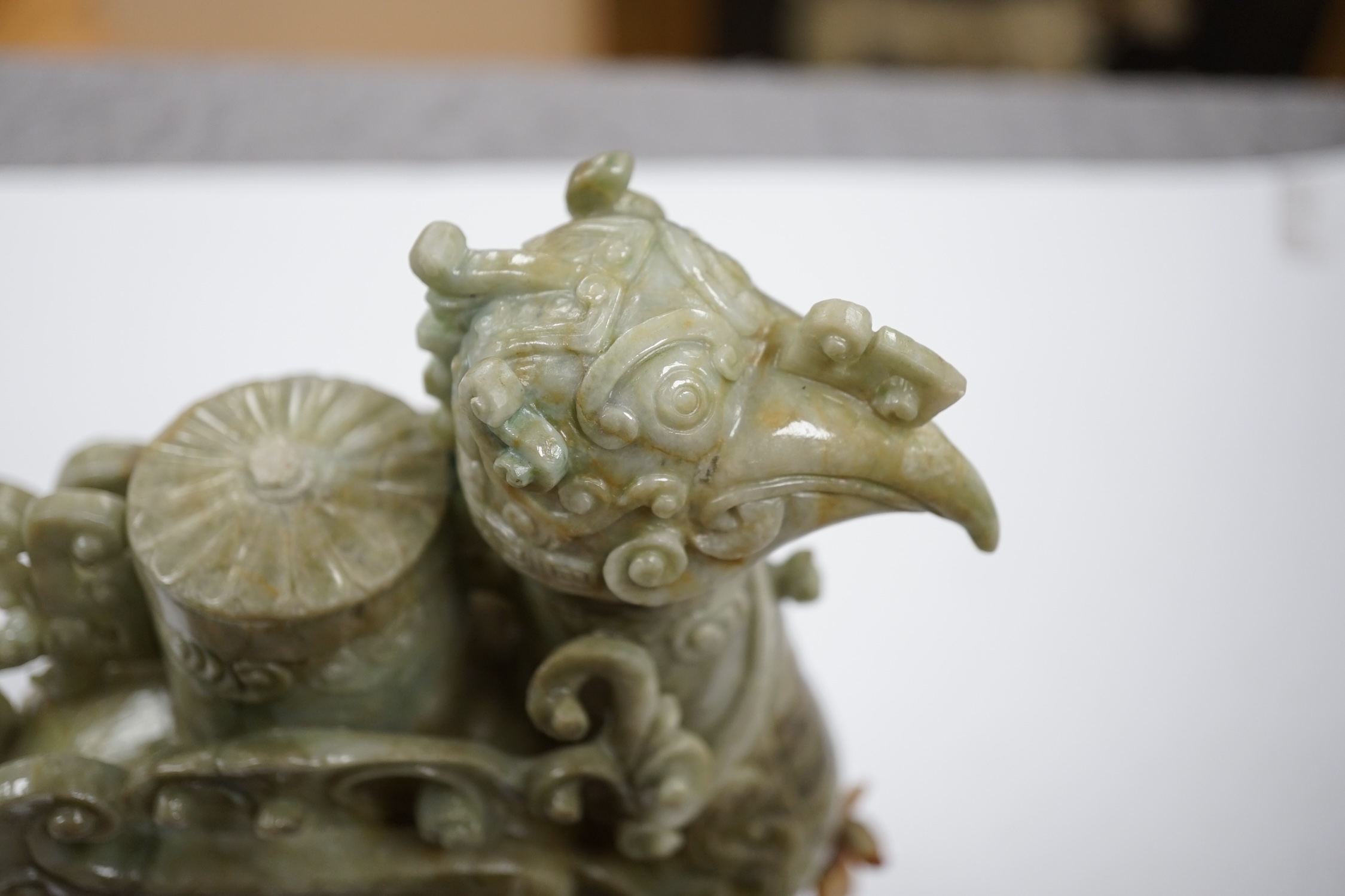 A large Chinese archaistic jadeite ‘phoenix’ vessel and cover, wood stand, 22cm high. Condition - fair